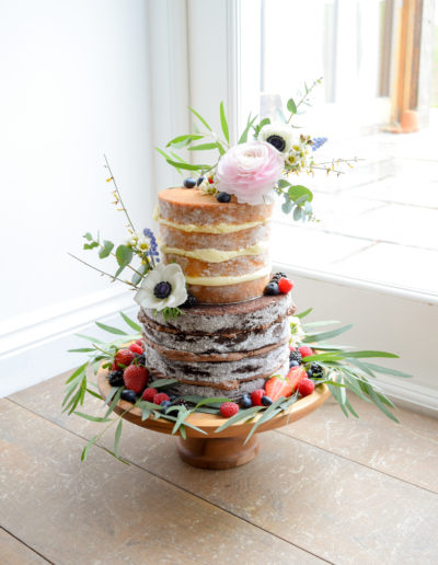 Wedding Cake - Wild Naked Cake With Floral Accents & Berries At Tregulland