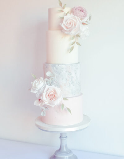 Wedding Cake - Textured four tier fondant finished cake dressed with hancrafted sugar blooms