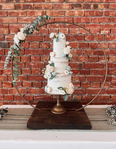 Luxury wedding cake Cornwall - Dollybird Bakes - Three tier semi naked buttercream wedding cake - Fresh florals - at The Green Cornwall